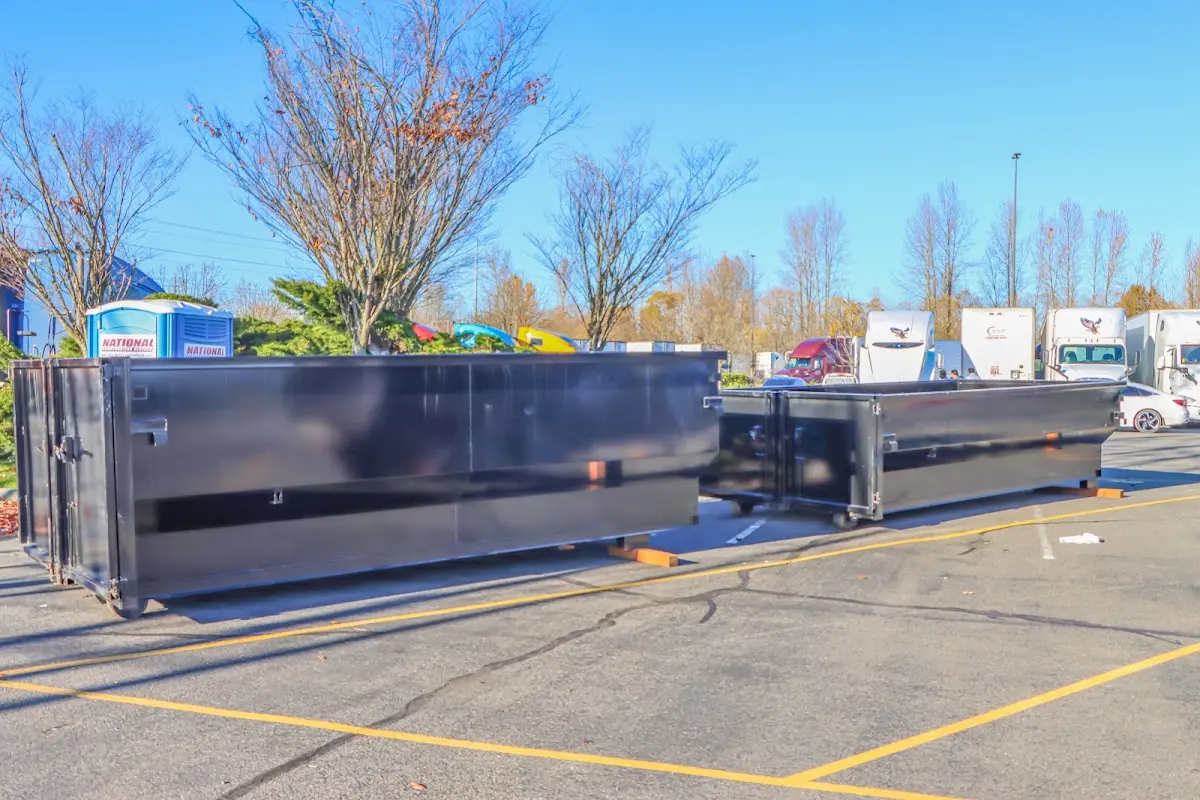 Professional dumpster rental service with roll-off container on residential driveway in Flagstaff